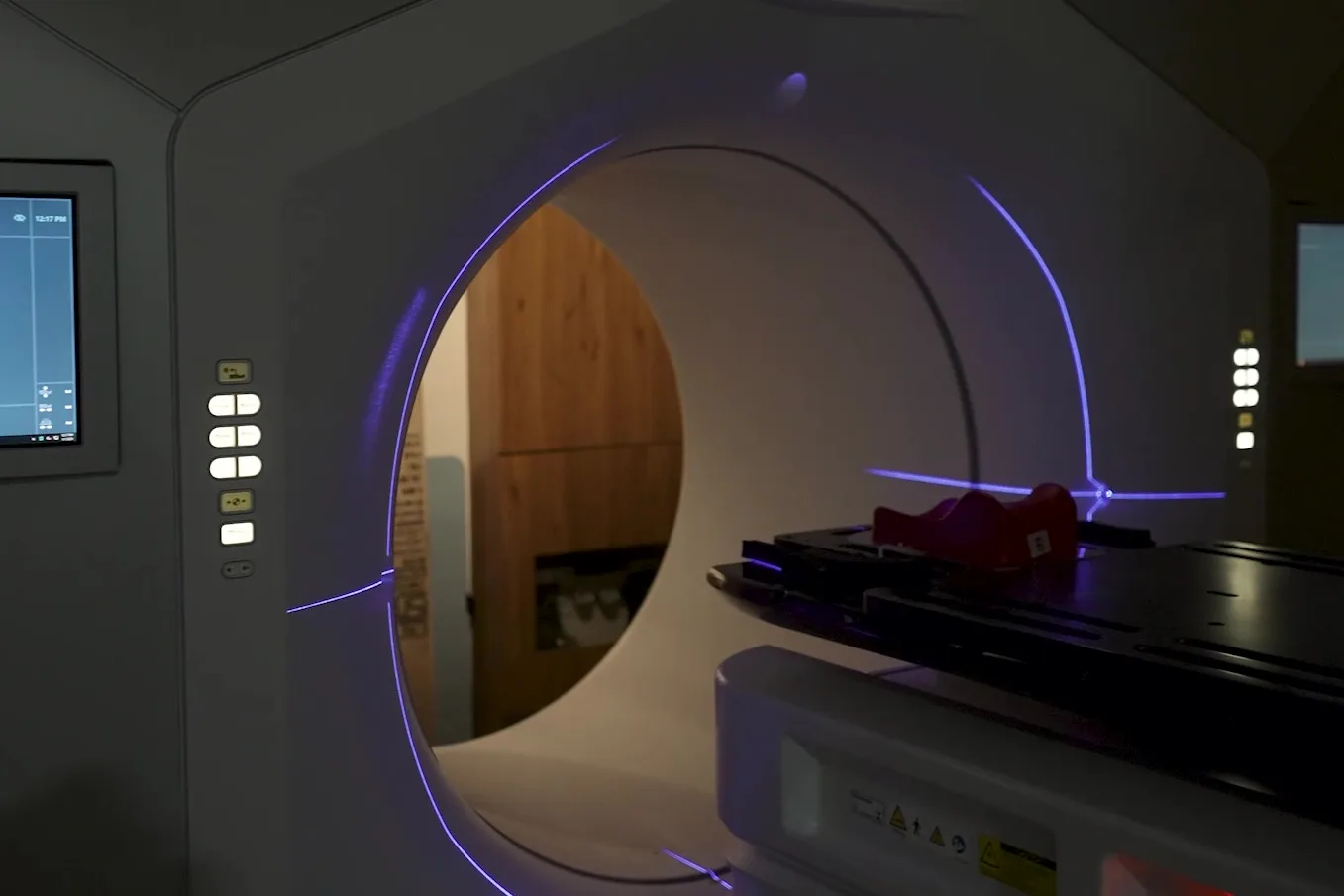 The radiotherapy machine at Junagadh, its ring lit and the treatment couch empty.