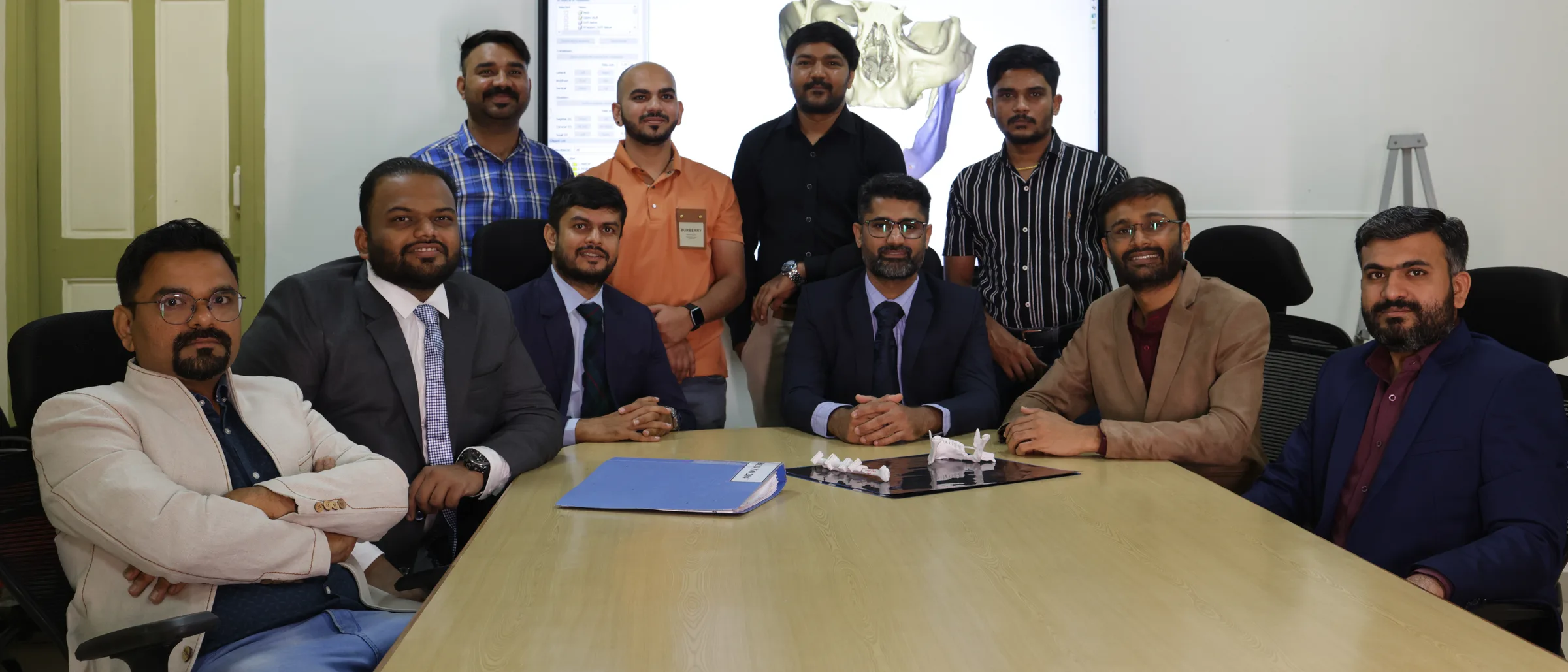 The tumour board team seated around their table.